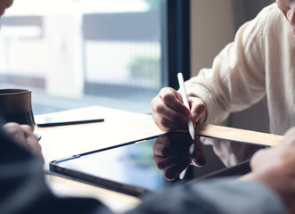 Asian businessman signing partnership agreement concept, male hand using stylus pen signing...