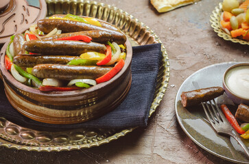 Arabic cuisine; Egyptian traditional sausage with onions, bell peppers and chili peppers. Served...
