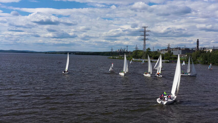 Aerial view of sailing yachts in a pond with rippled water surface. Video. Beautiful regattas...