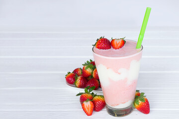 Strawberry yogurt fruit juice smoothie pink colorful fruit juice milkshake blend beverage healthy high protein the taste yummy In glass drink episode morning on white wood background.