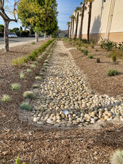 Water harvesting landscape to catch store and re-use storm water.