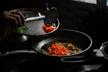 Cooking raw vegetables on the nonstick pan in the kitchen.Ingredients for cooking healthy breakfast. 