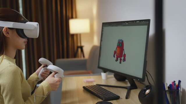 Asian Female Freelancer Working with Inspiration in her Studio. Concentrated Woman Creating her Own Project, She using VR to Control her Games Project by 3D Animation Software.