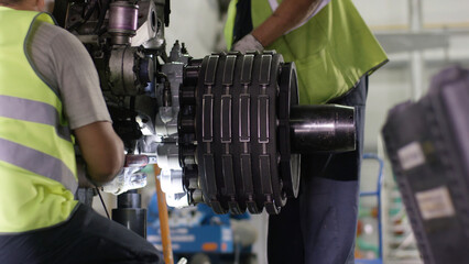 Calm workers controlling aircraft machine and chassis. Aircraft maintenance mechanic inspects plane...