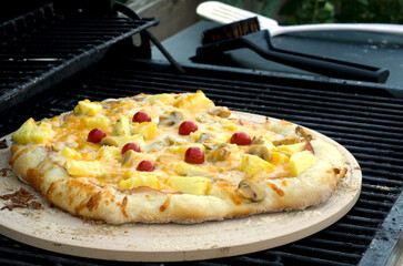 Delicious Ham, Pineapple and Tomato Homemade Pizza on BBQ