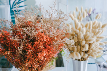 Dried grass flower in the vest with blur background.