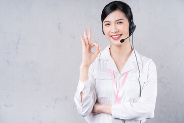 Portrait of young Asian operator on background