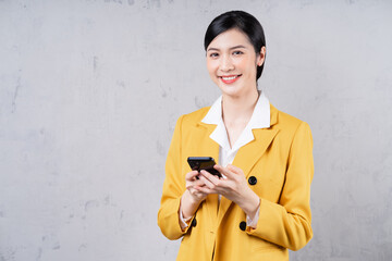 Fototapeta premium Photo of young Asian businesswoman holding phone