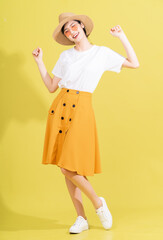 Full length photo of young Asian girl on yellow background