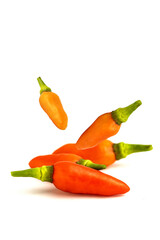 Falling red hot chilli peppers isolated on white background, clipping path