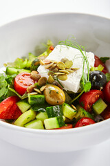 Greek salad in white bowl