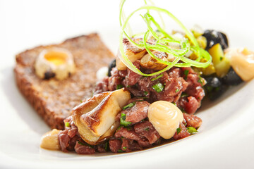 Beef tartare with greenery closeup view