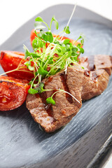 Grilled marbled beef with tomatoes closeup view