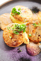 Fishcakes with garden cress closeup view