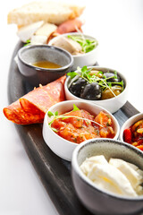 Wooden tray with snacks closeup view