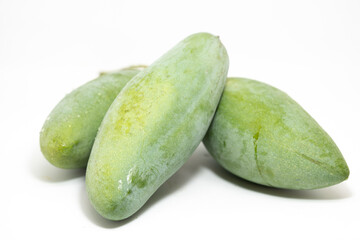 A raw mango fruit on a white background
