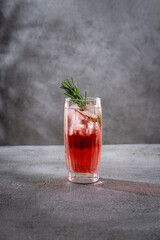Summer refreshing alcoholic cocktails. Raspberry lemonade garnished with fresh rosemary. Summer raspberry beverage with sparkling water.  Copy space.