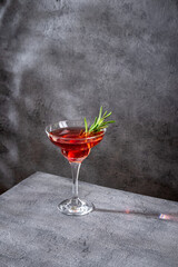 Summer refreshing alcoholic cocktail. Raspberry lemonade garnished with fresh rosemary. Summer raspberry beverage with sparkling water.  Copy space.