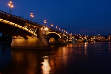 the Margaret bridge in Budapest. perspective view at bleu hour. illuminated steel arches....