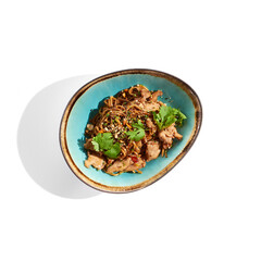 Japanese soba with chicken cooked on wok in asian style on white background. Noodle with chicken in ceramic bowl. Indonesian wok with soba noodles. Spicy thai dish with meat and udon.