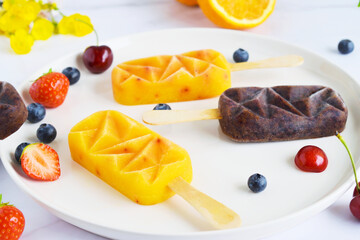 Home made ice cream with berries, orange, Summer food Top view