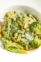 Veggie pasta with broccoli isolated on white background. Vegetarian dish - udon noodle with green vegetables. Vegan food in restaurant menu. Plant based dinning.