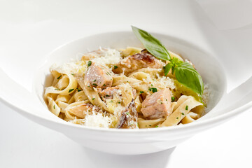 Traditional Italian lunch - pasta fettuccine with chicken and mushrooms with parmesan cheese. Creamy pasta with mushroom and chicken. Chicken and mushroom in cream sauce with homemade pasta.