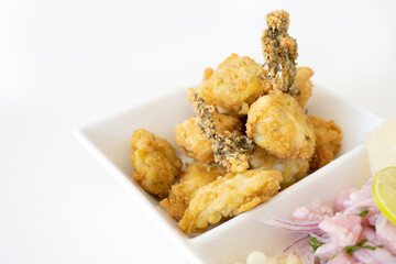 Peruvian food: chicharron de pescado or fish cracklings. White background