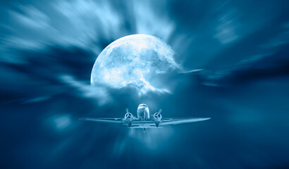 Old metallic propeller airplane in the sky with full moon "Elements of this image furnished by NASA"