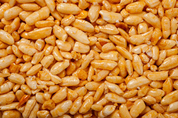 Sweetness from grains of puffed rice, shot close-up on a white background.