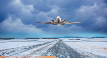 Metallic airplane old propeller fly up over take-off runway the (ice) snow-covered airport