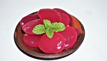 Palm fruit on a ground plate (cobek) on a white background.
