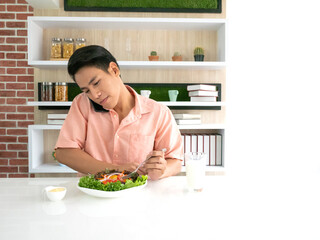 Asian business owner man eating salad with fresh milk and call to the employee together show...