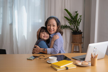 Portrait of an elderly woman and granddaughter hugging each other to show affection and family activities.