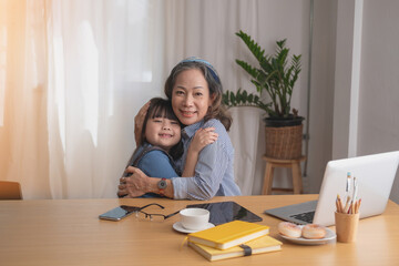 Portrait of an elderly woman and granddaughter hugging each other to show affection and family activities.