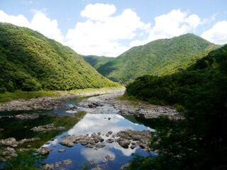 Naklejka na ściany i meble A river flowing in the mountains of Japan