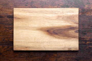 Cutting board on wood kitchen table. Food recipe concept at wood background texture with copy space.