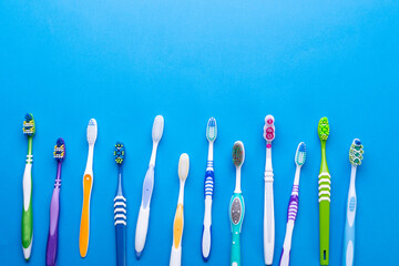 Toothbrushes on blue background. Space for text. Top view.