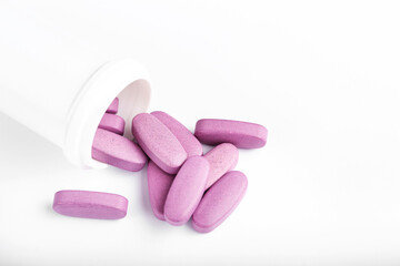 Pink medical pills and tablets spilling out of a drug bottle. Antidepressant drugs meds.