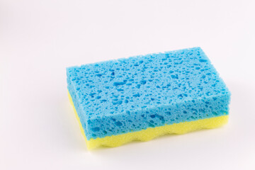 Yellow- blue sponge for washing dishes close-up