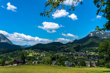 Beautiful idyllic panorama view of village near Altaussee on a sunny summer day with blue sky cloud, in Ausseerland - Salzkammergut region, Styria, Austria - 518892516