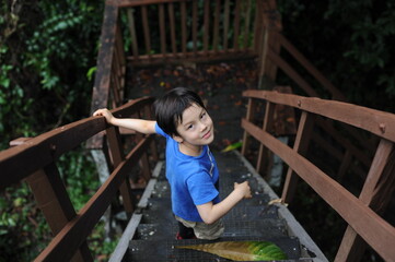 Obraz premium Portrait of a young boy standing on a playground in summer