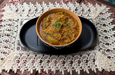 Lauki or Doodhi Chana Dal Subji or Bottle gourd Gram Curry, served in a while bowl. selective focus