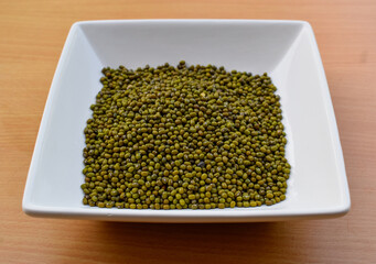 Green gram dal or green moong in white bowl.