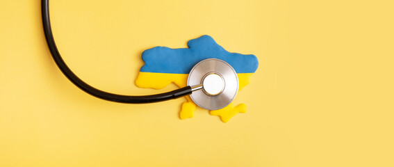 Banner with stethoscope and Ukraine map in national flag colors of Ukraine blue and yellow, war in Ukraine, medical care in the war