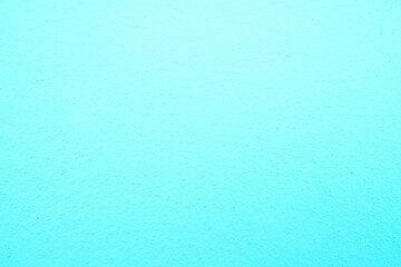 abstract, rough plaster wall texture is light blue for backgroun