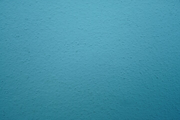 abstract, rough plaster wall texture is light blue for backgroun