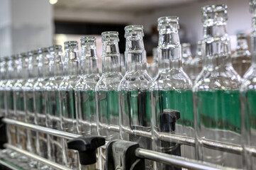 Row of glass bottles to fill with expensive alcohol drinks