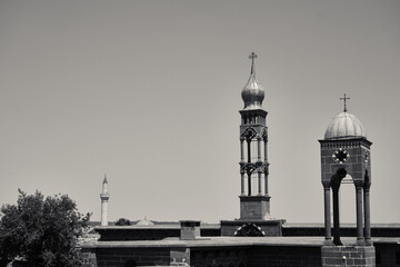 Fototapeta premium Top of Mar Petyun Keldani Church, Armenian Church and muslim mosque in one photo in Diyarbakir.