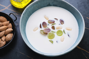 Bowl of spanish traditional ajoblanco made of white bread, almonds, garlic, water and olive oil,...